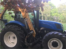New Holland Tractor with Boom Mower Attachment